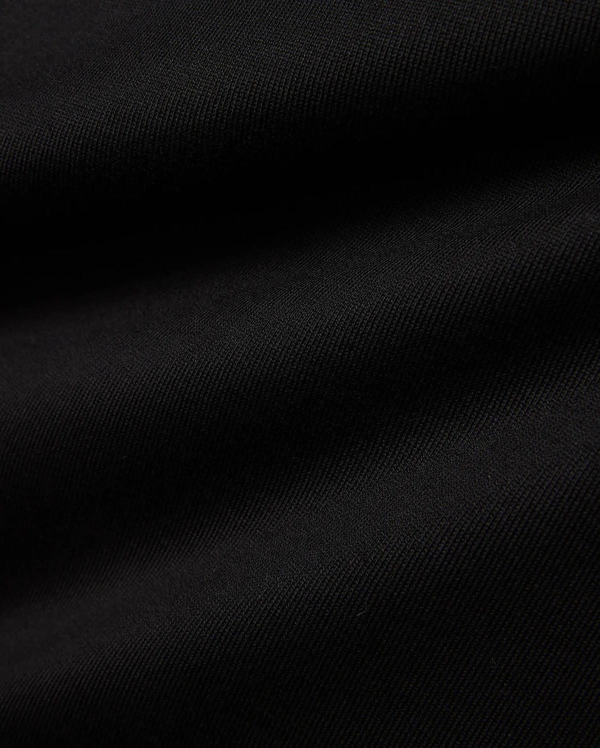 Men's Samson Oversized Bunny Tee, a black premium jersey knit fabric with a subtle diagonal texture, embodying Psycho Bunny's refined streetwear aesthetic. (6)