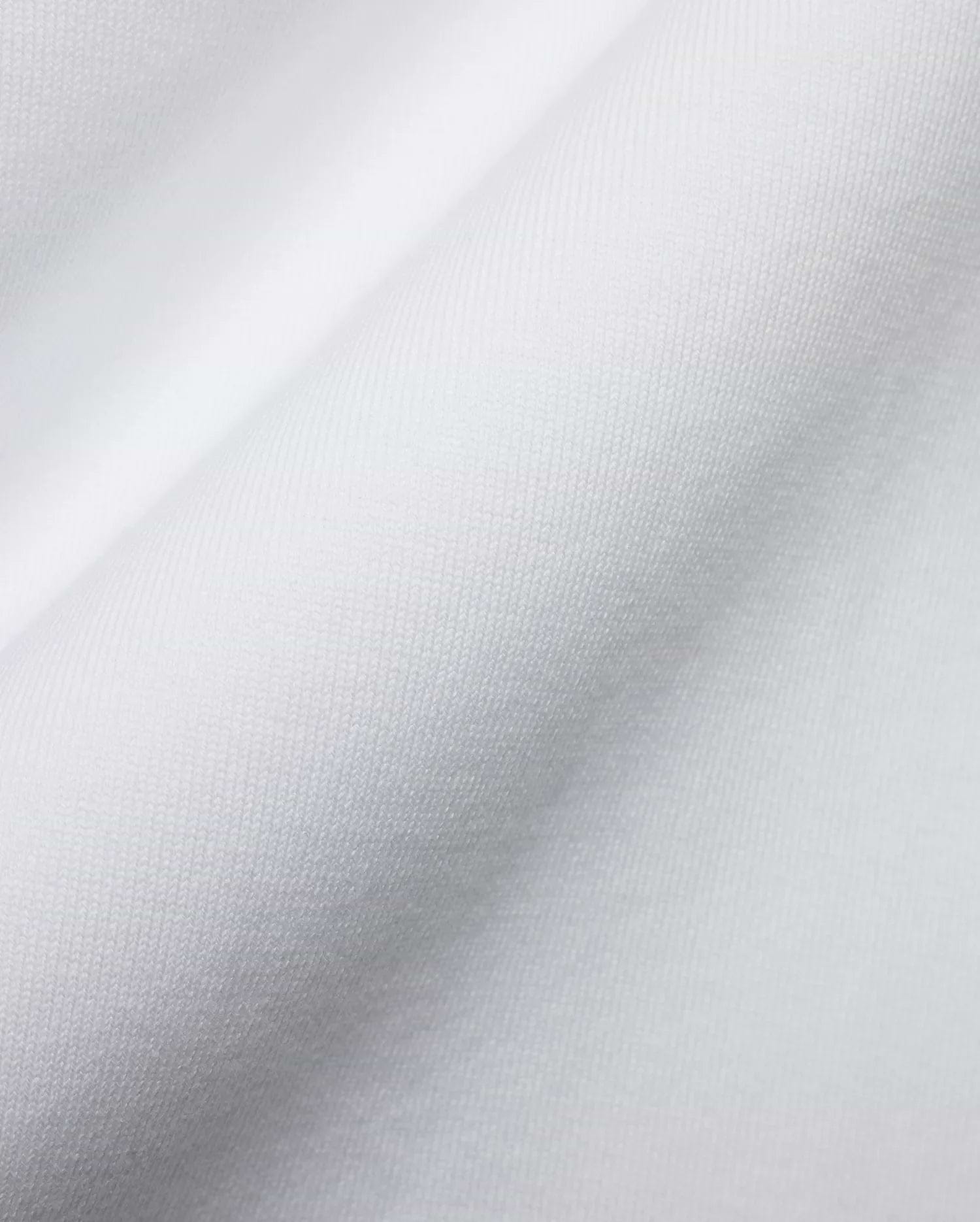 Men's Samson Oversized Bunny Tee, crafted from luxurious white jersey knit fabric with a fine, soft texture and subtle draping, reflecting Psycho Bunny's premium streetwear style and iconic bunny skull branding. (6)