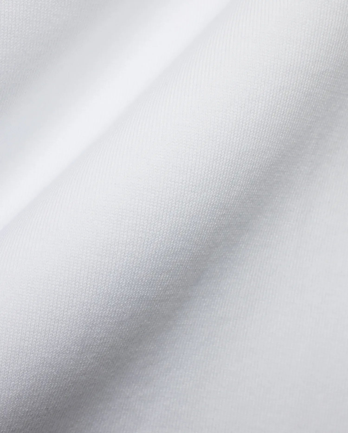Men's Samson Oversized Bunny Tee, crafted from luxurious white jersey knit fabric with a fine, soft texture and subtle draping, reflecting Psycho Bunny's premium streetwear style and iconic bunny skull branding. (6)