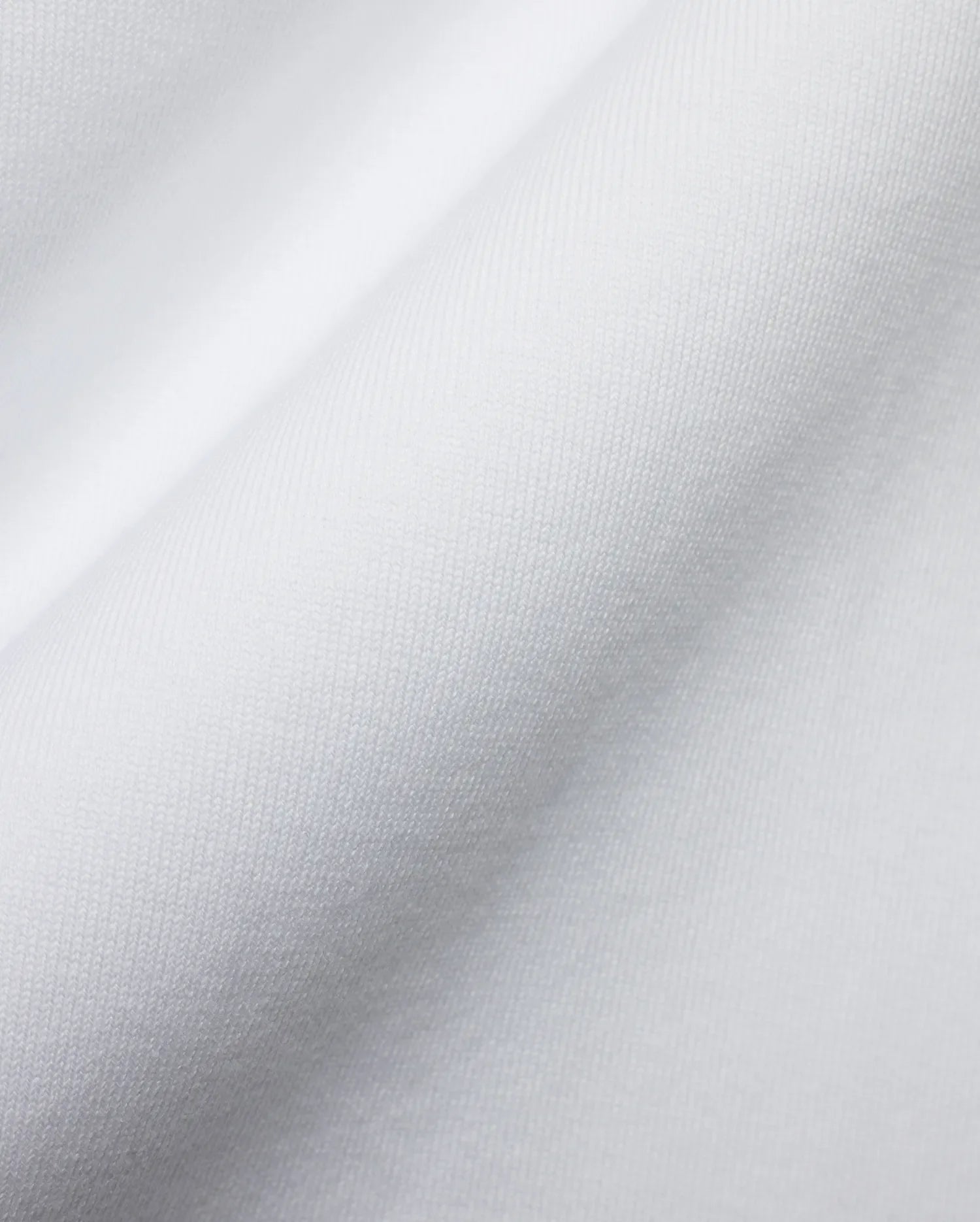 Men's Samson Oversized Bunny Tee, crafted from luxurious white jersey knit fabric with a fine, soft texture and subtle draping, reflecting Psycho Bunny's premium streetwear style and iconic bunny skull branding. (6)