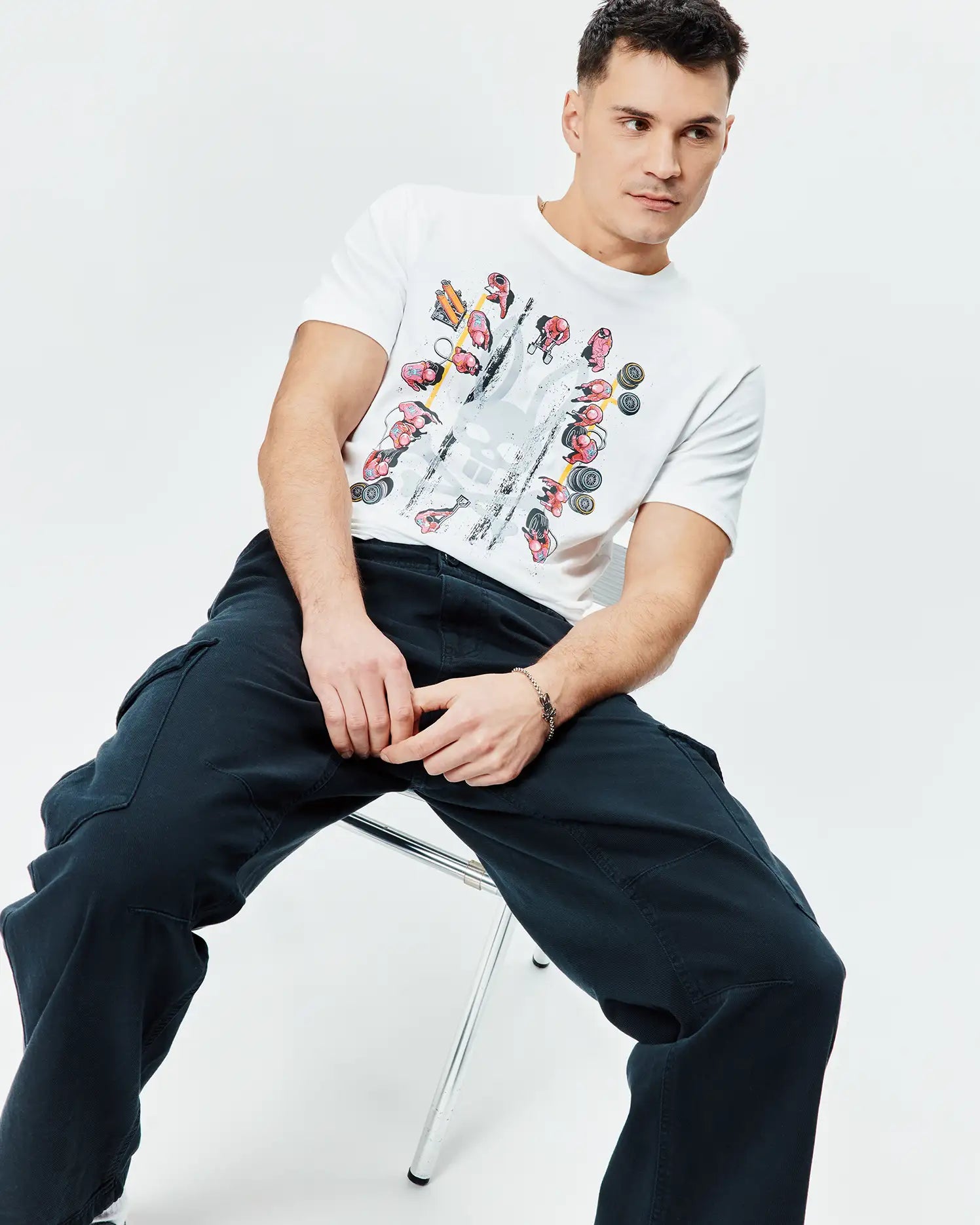 Mens Race Bunny Graphic Tee: White classic fit jersey t-shirt with a large central graphic print featuring colorful race cars, drivers, and a distressed Psycho Bunny skull logo.