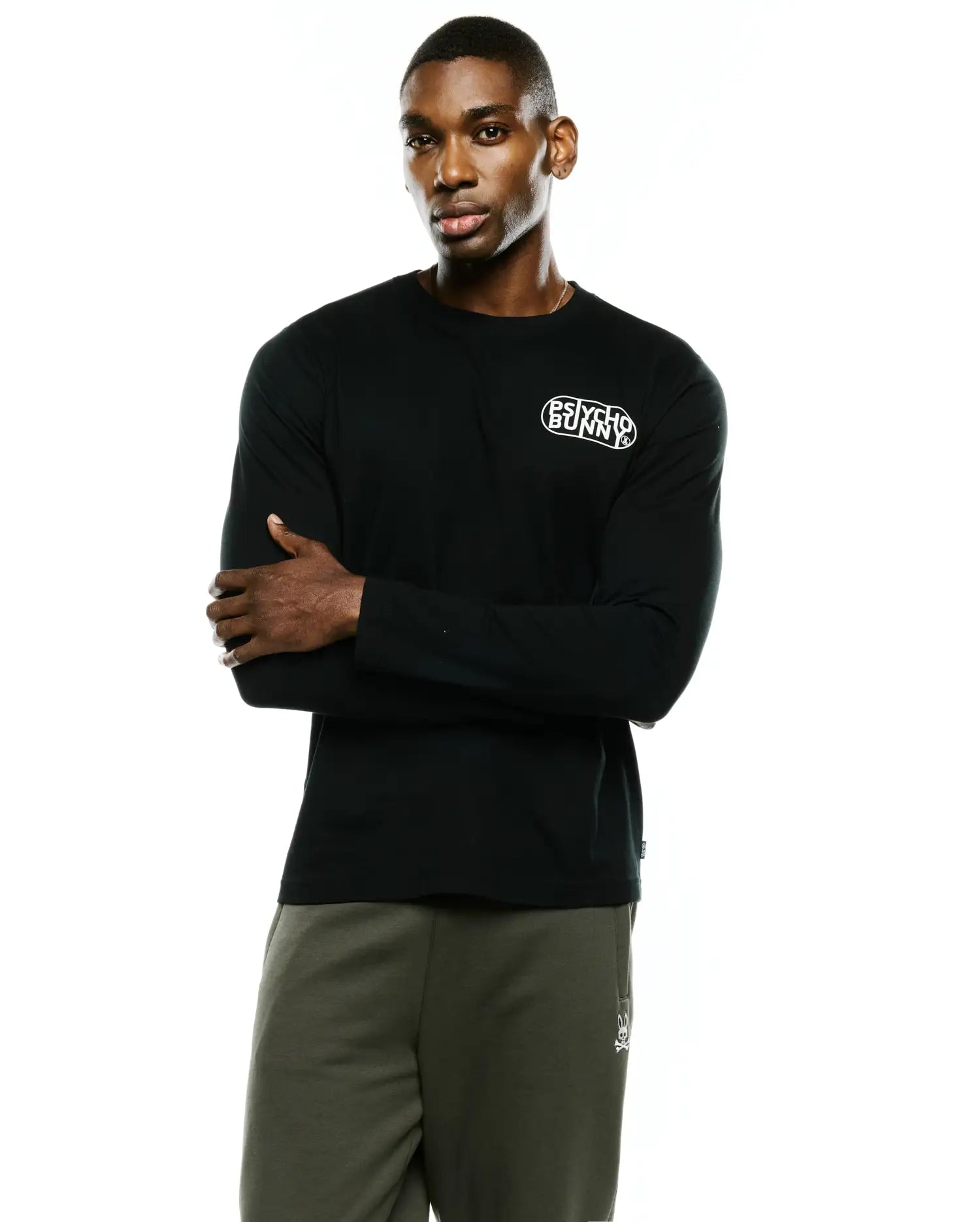 Mens Dariel Long Sleeve Back Graphic Tee in black, a classic fit, smooth jersey knit tee with a small white Psycho Bunny text logo on the left chest.