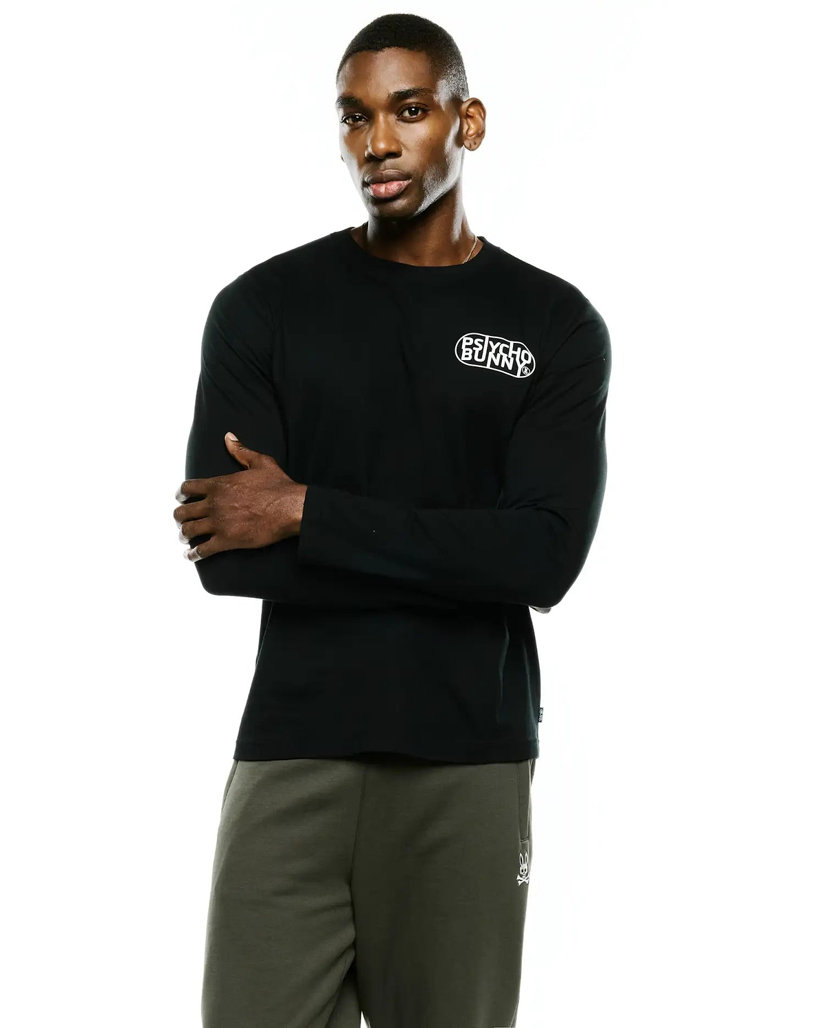 Mens Dariel Long Sleeve Back Graphic Tee in black, a classic fit, smooth jersey knit tee with a small white Psycho Bunny text logo on the left chest.