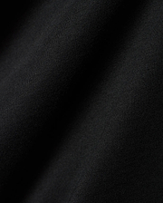 Black Mens Dariel Long Sleeve Back Graphic Tee, crafted from premium, soft jersey knit fabric with subtle vertical texture and elegant folds, reflecting refined streetwear quality.