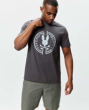 Mens Santa Fe Bunny Graphic Tee, a dark grey classic fit jersey t-shirt featuring a large white circular Psycho Bunny skull logo and text graphic centered on the chest. (2)
