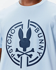 Mens Santa Fe Bunny Graphic Tee, a light blue jersey knit t-shirt with a classic fit, featuring a large navy Psycho Bunny skull and crossbones logo graphic on the central chest, encircled by PSYCHO BUNNY text. (3)
