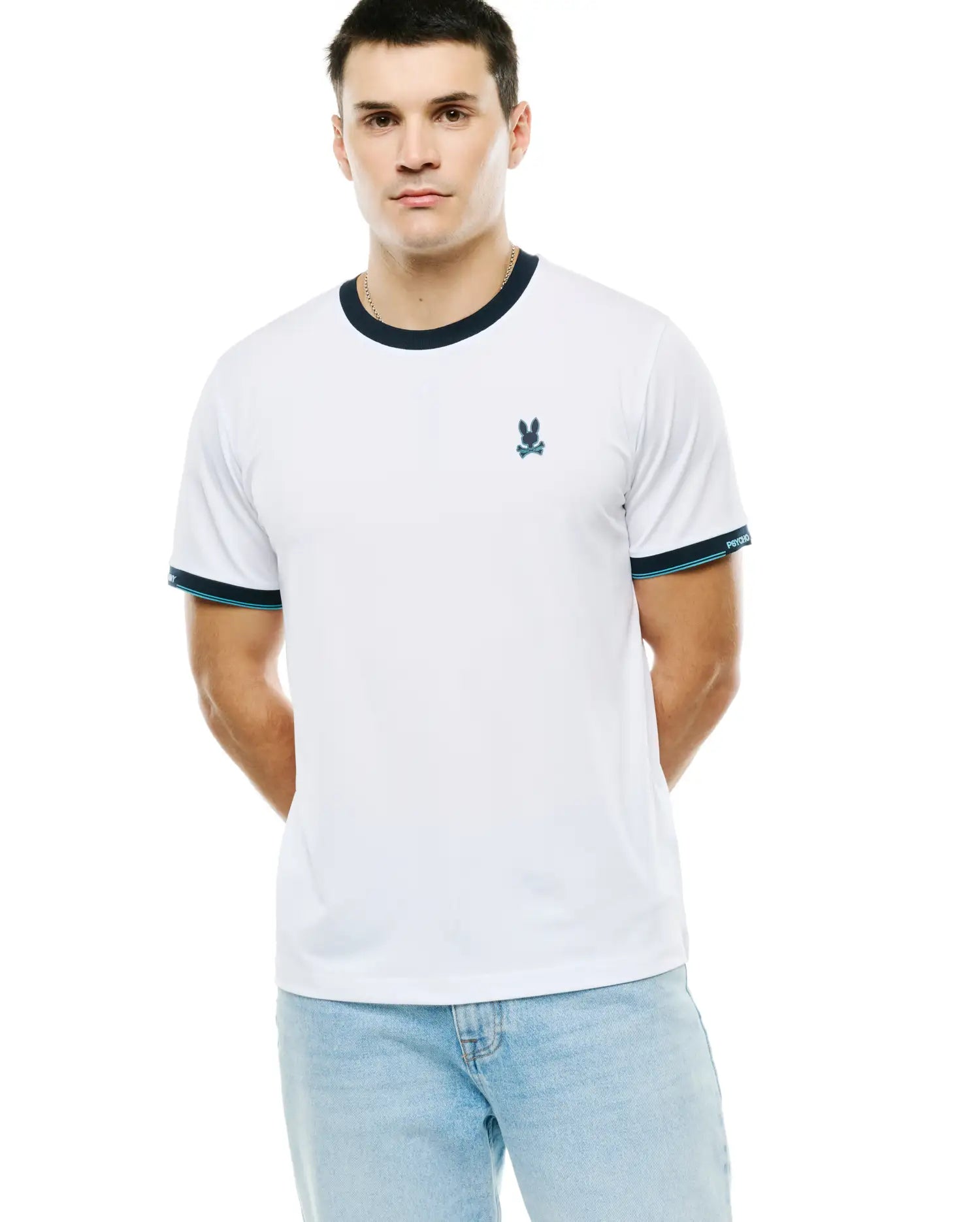 Men's Edmonds Chest Bunny Sport Tee, a white jersey knit t-shirt with navy ringer collar and cuffs, featuring a teal stripe and Psycho Bunny text on sleeves, plus a small embroidered teal bunny skull logo on the left chest. (2)
