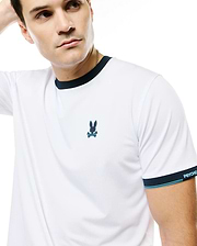 Men's Edmonds Chest Bunny Sport Tee, white performance jersey with navy ringer collar and sleeve cuffs, light blue stripes, embroidered chest bunny skull logo, and PSYCHO BUNNY text on cuff. (3)