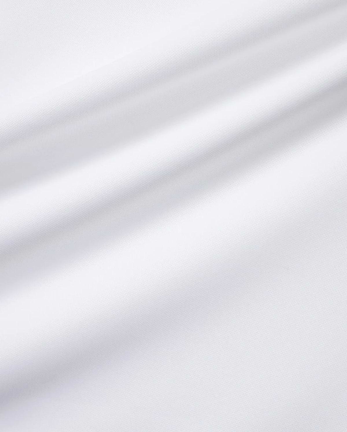 Close-up of the white Men's Edmonds Chest Bunny Sport Tee, showcasing its premium, subtly textured performance jersey fabric, with an implied small embroidered Psycho Bunny skull logo. (6)