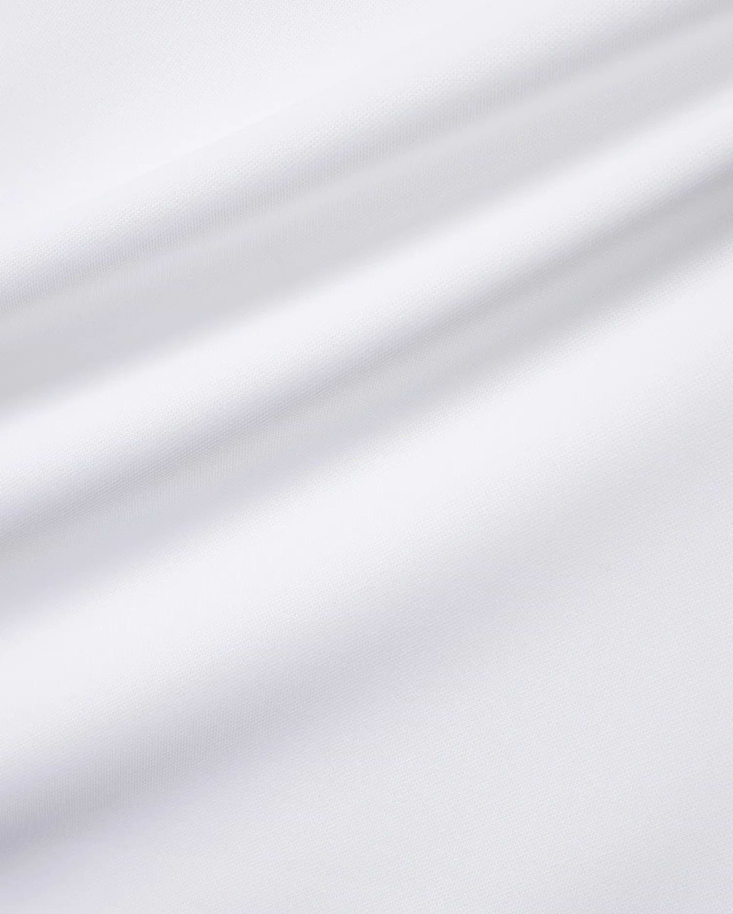 Close-up of the white Men's Edmonds Chest Bunny Sport Tee, showcasing its premium, subtly textured performance jersey fabric, with an implied small embroidered Psycho Bunny skull logo. (6)