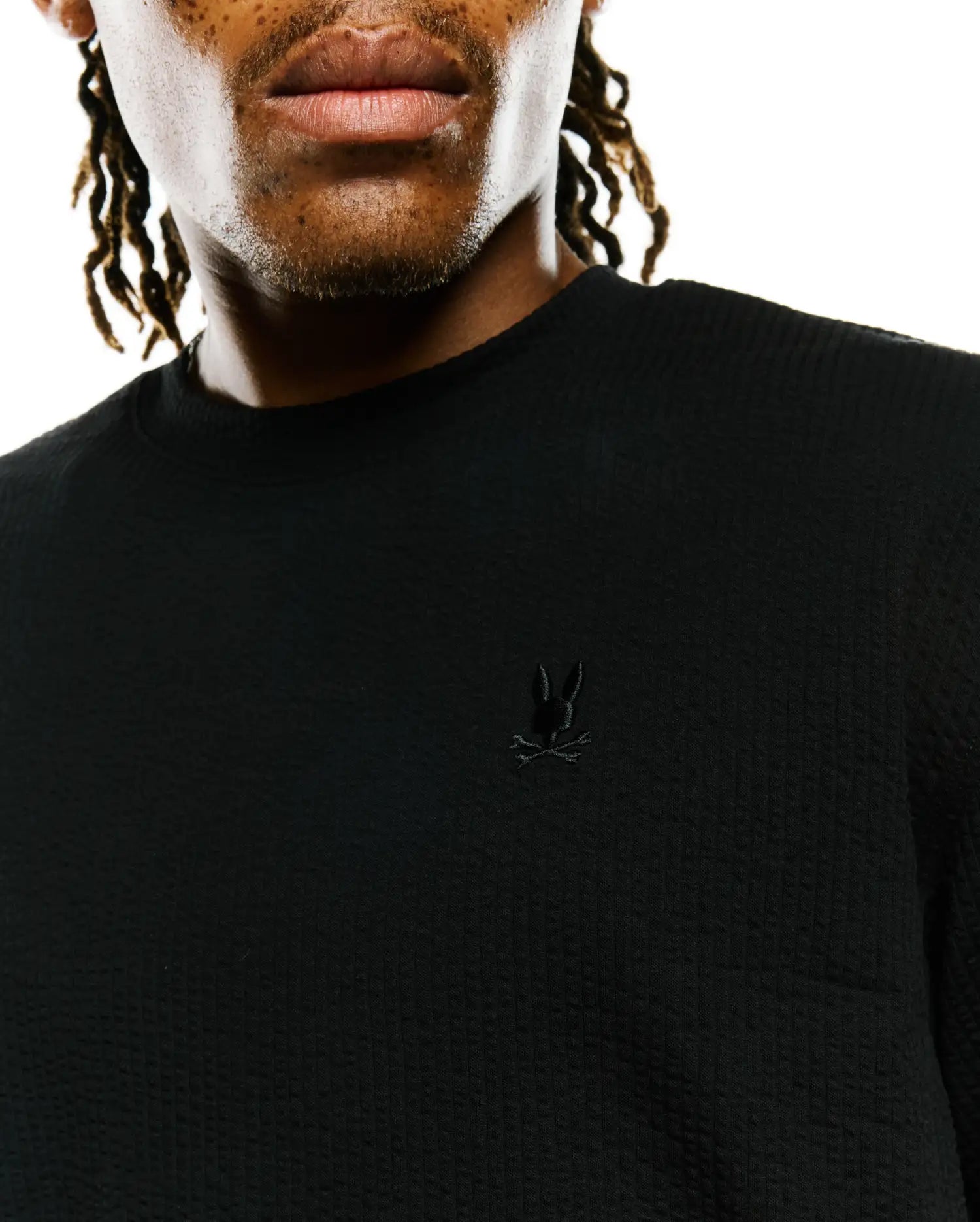 Mens Arlen Relaxed Seersucker Tee, black, featuring a textured seersucker fabric and a small, tonal embroidered Psycho Bunny skull logo on the left chest. (3)