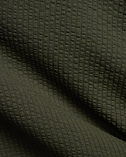Mens Arlen Relaxed Seersucker Tee in deep olive green, showcasing its distinctive vertical puckered seersucker knit texture with subtle shadows.