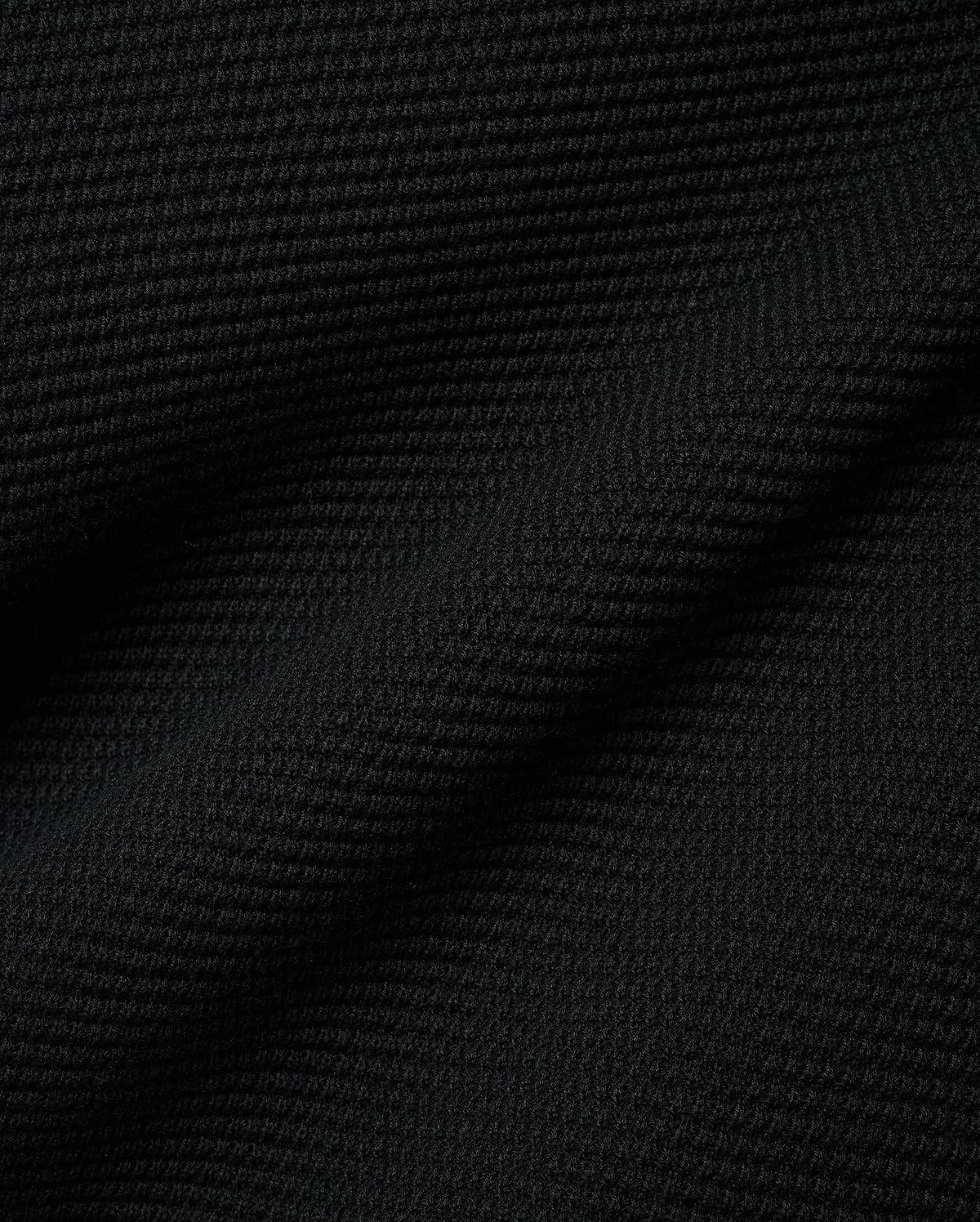 Black Makai Textured Knit T-Shirt, a premium streetwear garment featuring a distinct, small-scale horizontal textured knit pattern, reflecting Psycho Bunny's refined aesthetic.