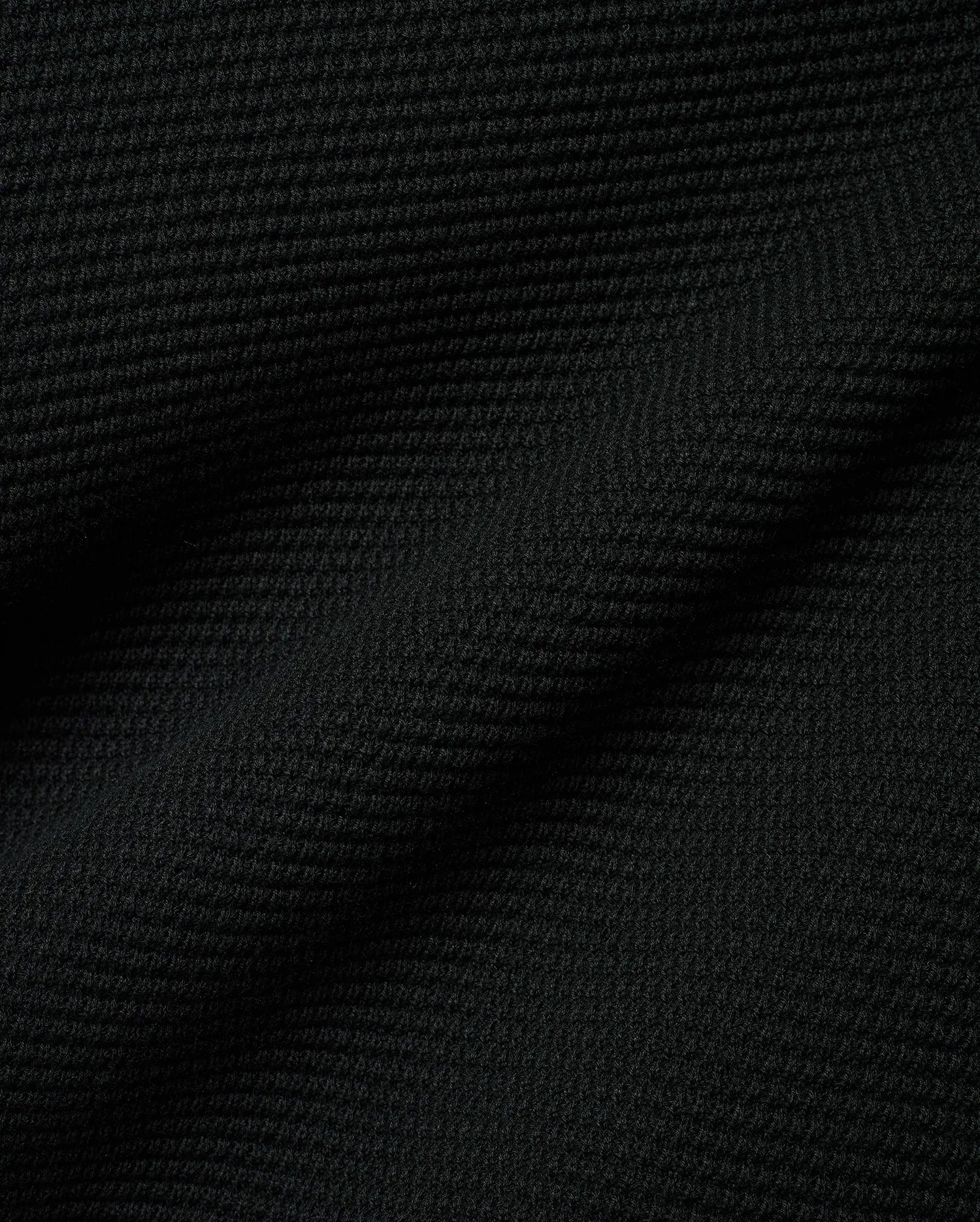 Black Makai Textured Knit T-Shirt, a premium streetwear garment featuring a distinct, small-scale horizontal textured knit pattern, reflecting Psycho Bunny's refined aesthetic.