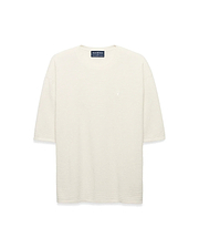 Mens Makai Textured Knit T-Shirt in cream, featuring a relaxed fit, subtle horizontal textured knit, and a small tonal embroidered Psycho Bunny skull logo on the left chest.