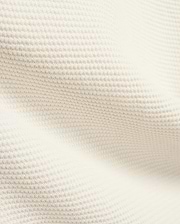 Mens Makai Textured Knit T-Shirt in creamy off-white, showcasing a refined, subtly raised pique-like knit fabric texture, ideal for premium Psycho Bunny streetwear style.