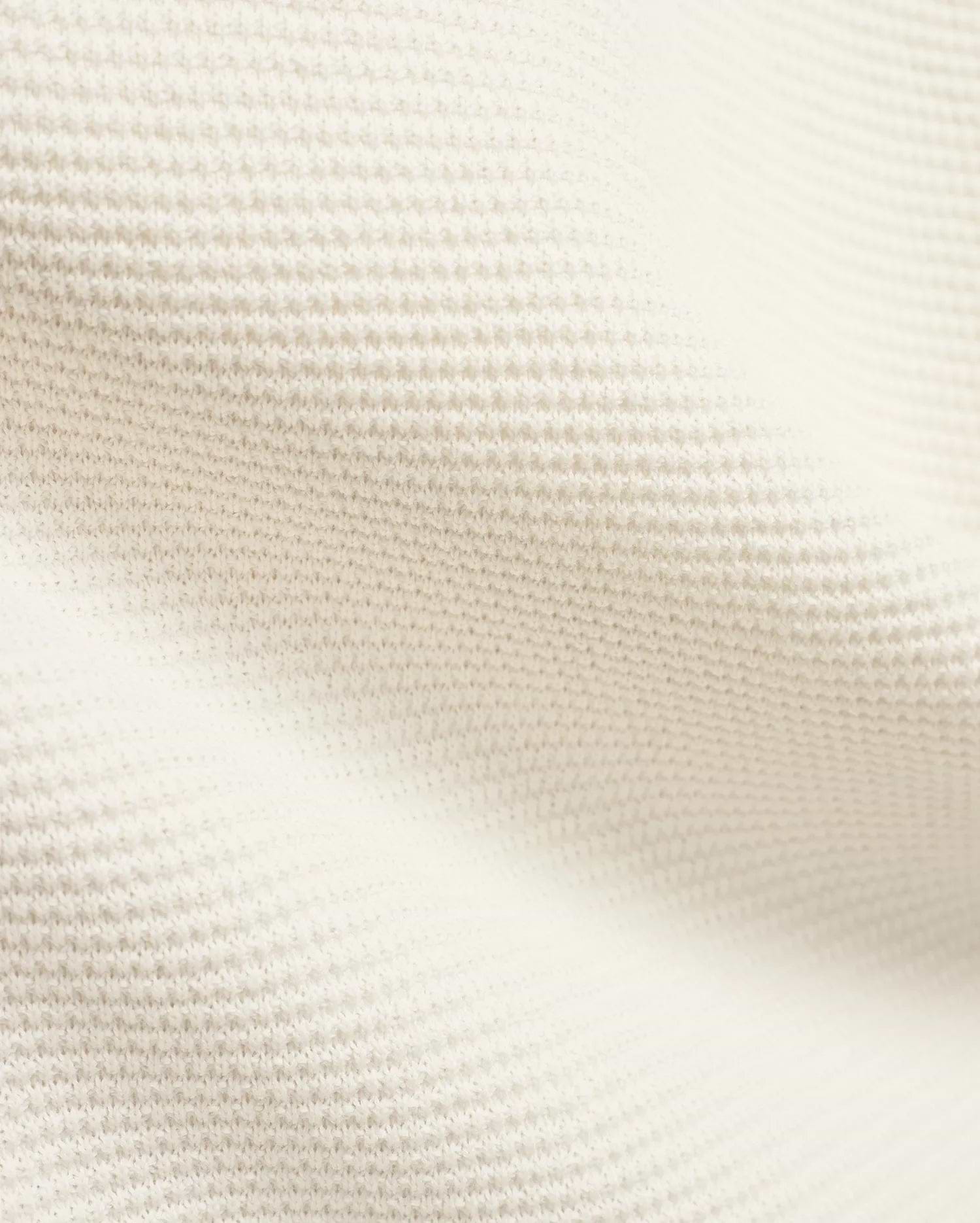 Mens Makai Textured Knit T-Shirt in creamy off-white, showcasing a refined, subtly raised pique-like knit fabric texture, ideal for premium Psycho Bunny streetwear style.