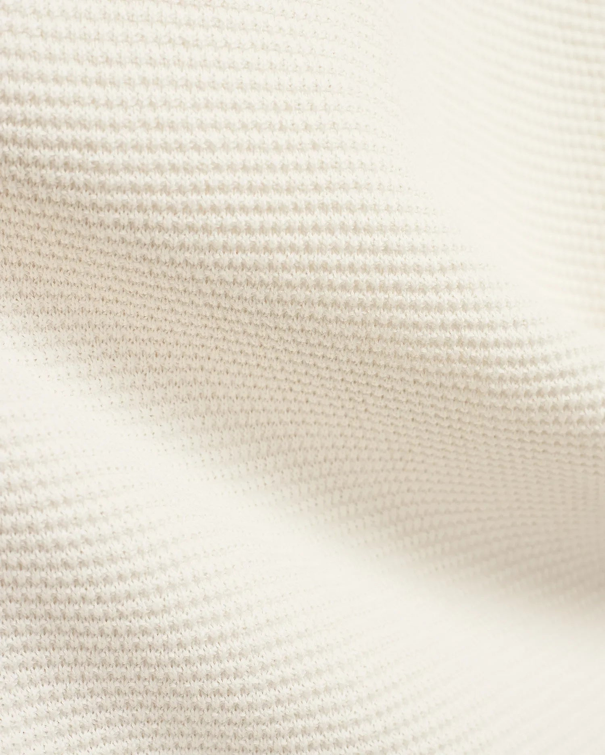 Mens Makai Textured Knit T-Shirt in creamy off-white, showcasing a refined, subtly raised pique-like knit fabric texture, ideal for premium Psycho Bunny streetwear style.