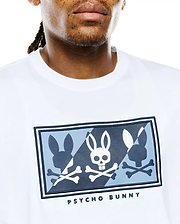 Mens Desmond Graphic Tee in white jersey knit, featuring a large chest graphic with three bunny skull and silhouette designs in white, light blue, and dark blue on a patterned background, bordered in dark blue, with PSYCHO BUNNY text below.