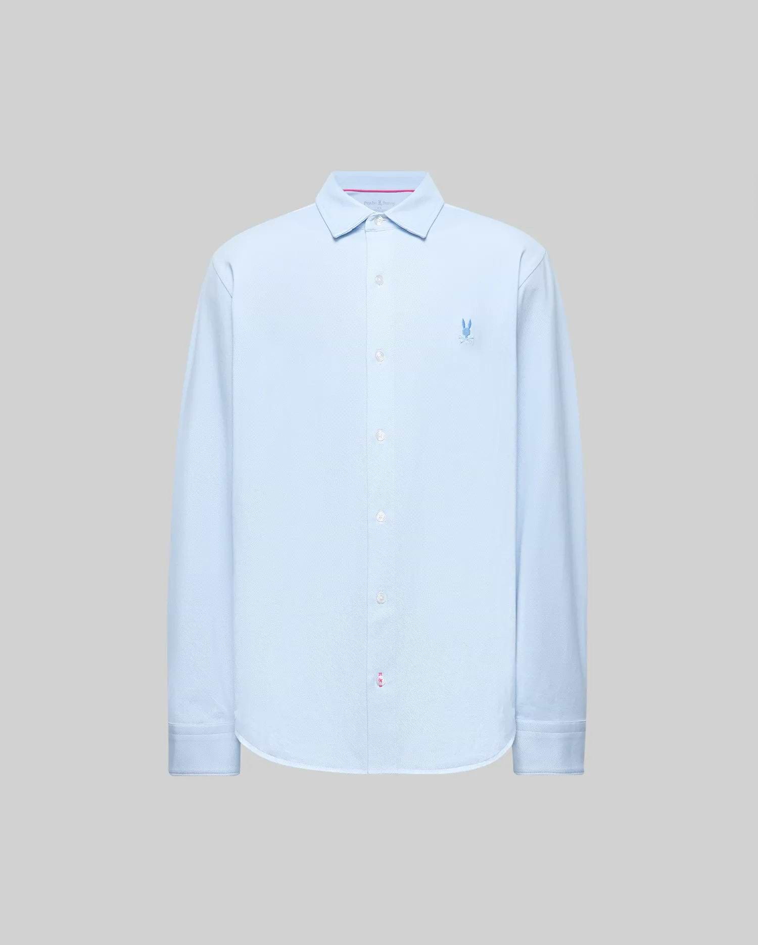 The Psycho Bunny MENS JIM JERSEY STRIPED KNIT SHIRT (MT0300041) is a light blue, long-sleeve, collared button-up with a subtle logo on the left chest, made from soft cotton jersey and shown against a plain gray background.