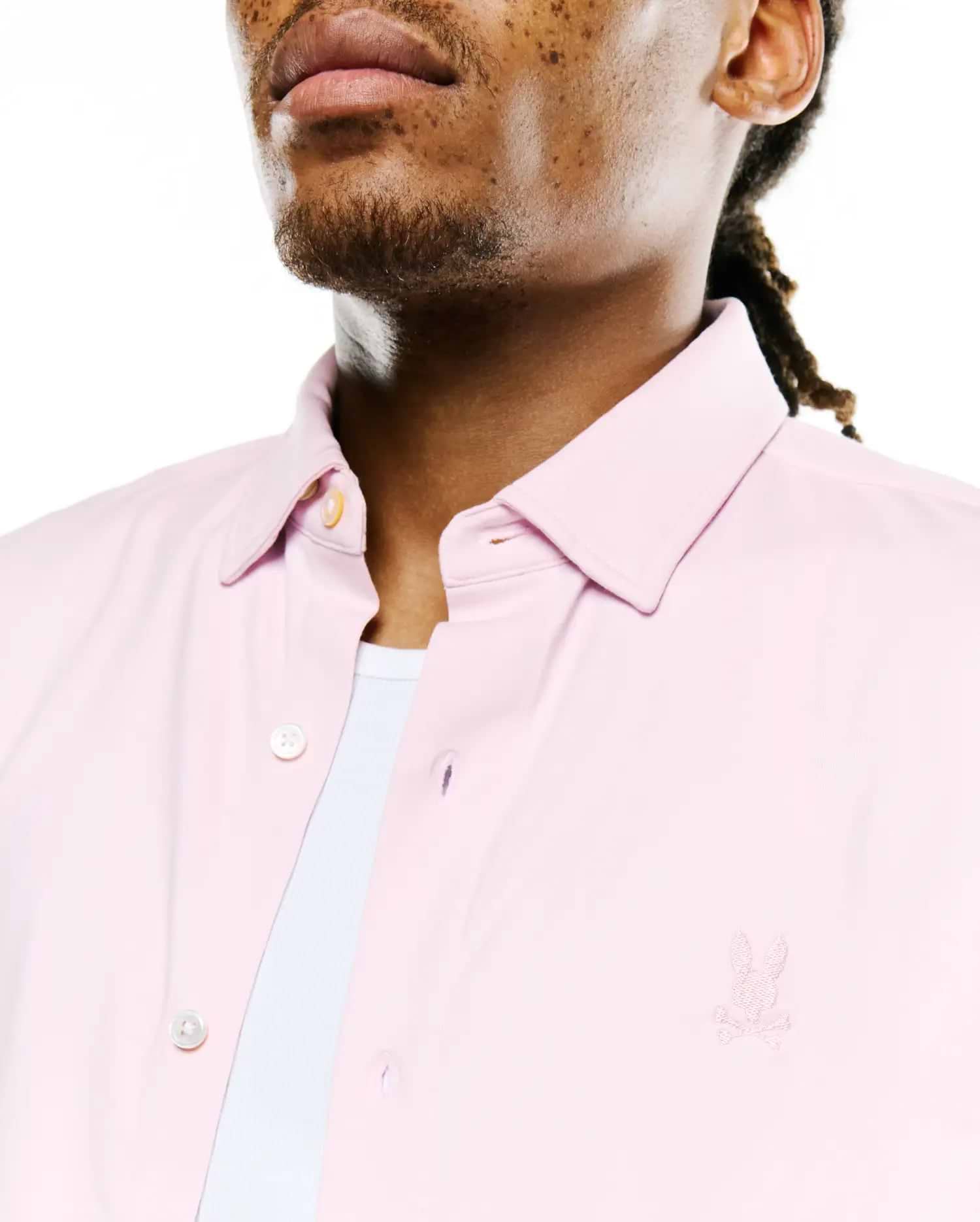 Men's Jim Jersey Longsleeve Shirt in light pink, featuring a classic fit, button-down collar, cream buttons, and a small embroidered Psycho Bunny skull logo on the left chest. (2)