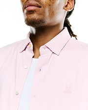 Men's Jim Jersey Longsleeve Shirt in light pink, featuring a classic fit, button-down collar, cream buttons, and a small embroidered Psycho Bunny skull logo on the left chest. (2)