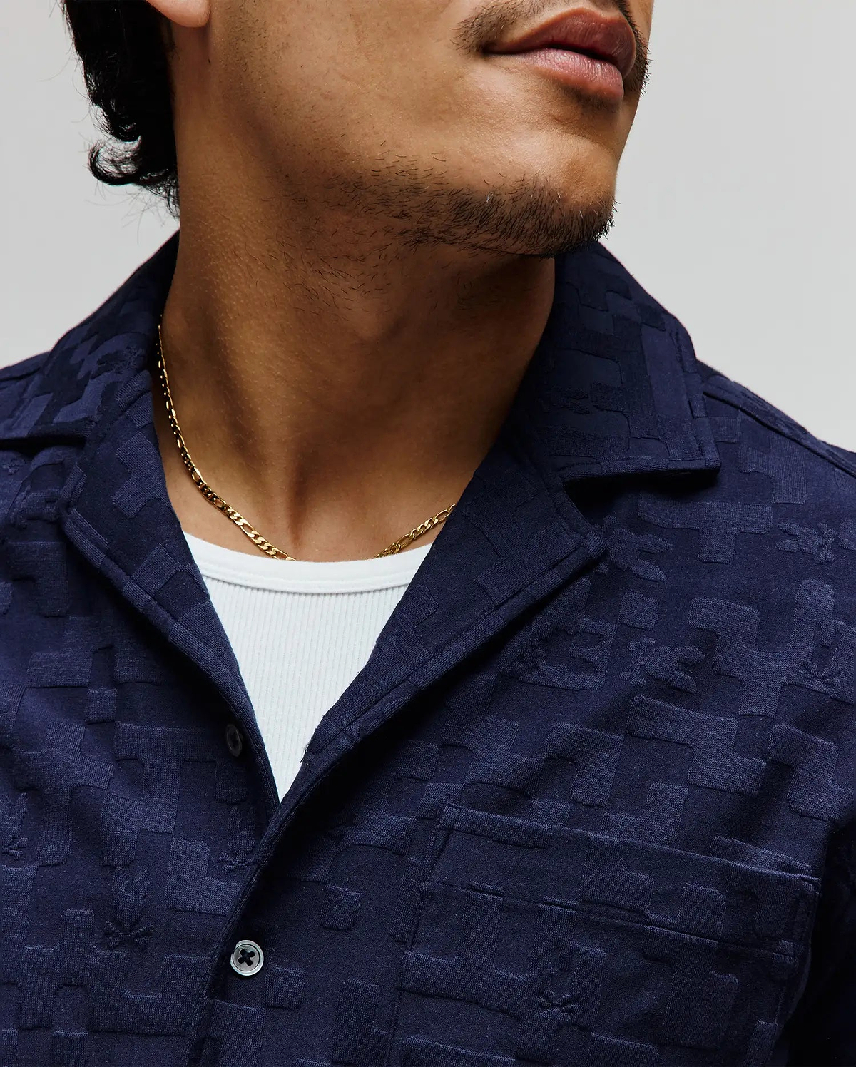 Mens Josh Jacquard Shirt in deep navy, crafted from soft, textured jacquard fabric with a subtle all-over bunny skull pattern, featuring a relaxed camp collar, front button closure, and a chest pocket.