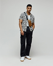 Mens Josh Jacquard Shirt, a white shirt with a black pixelated jacquard pattern featuring integrated Psycho Bunny skull logos, in a relaxed fit.
