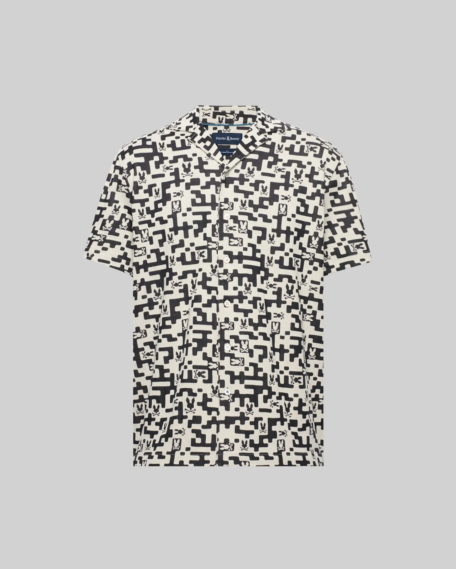 Mens Josh Jacquard Shirt, cream short-sleeve with black all-over geometric and small Psycho Bunny skull pattern, relaxed fit, soft jacquard fabric.