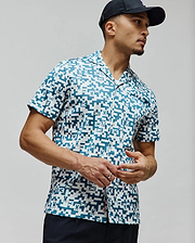 Mens Josh Jacquard Shirt, a relaxed fit white jacquard shirt with an all-over teal pixelated geometric pattern subtly incorporating small Psycho Bunny skull logos, finished with a camp collar.