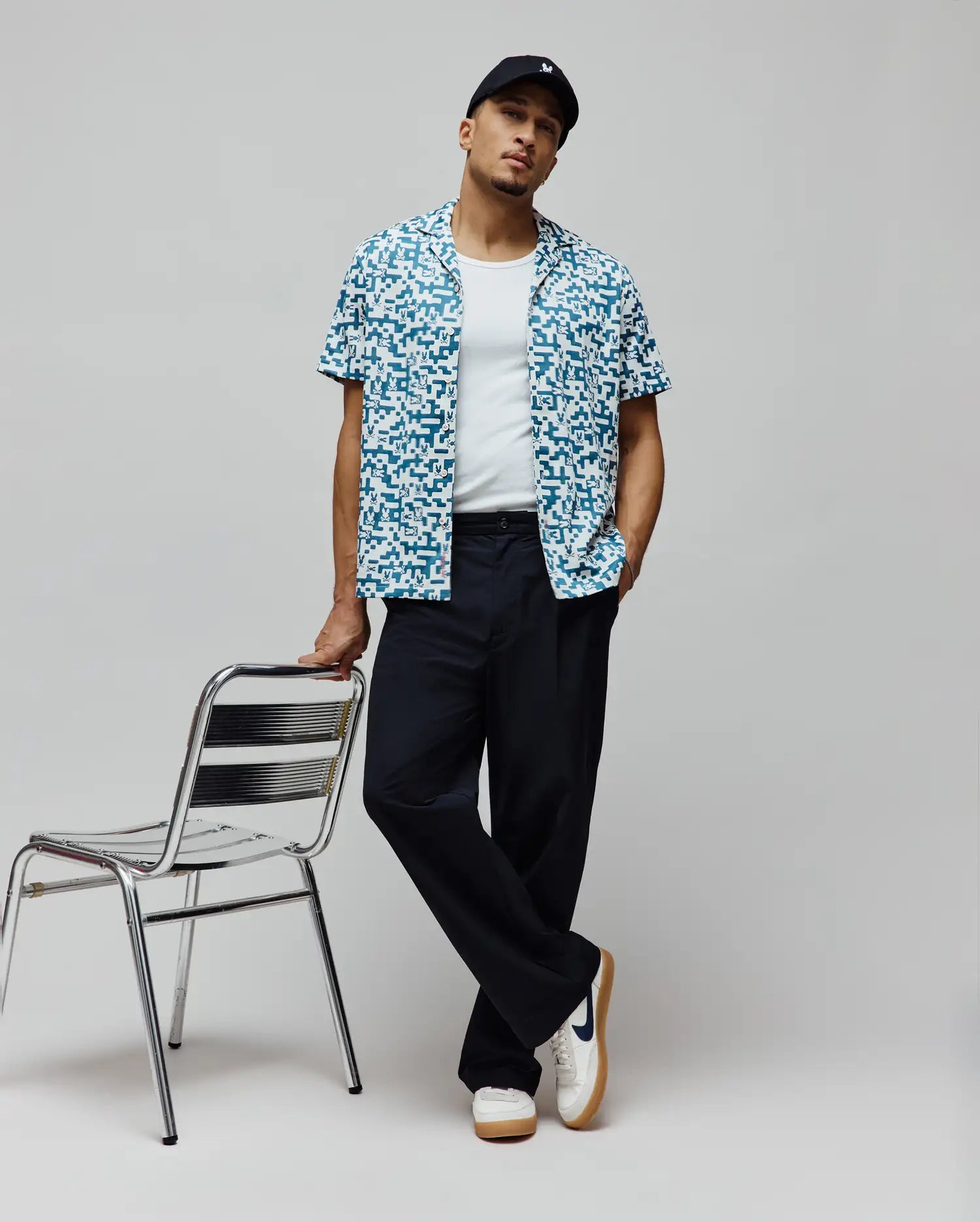 Mens Josh Jacquard Shirt, a relaxed fit short-sleeve button-up in teal and white, featuring an all-over pixelated jacquard pattern with integrated small Psycho Bunny skull logos.