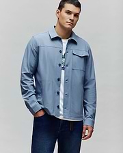 Mens Maverick Overshirt, a dusty blue classic fit overshirt with a smooth finish, black buttons, multiple patch pockets, and a small embroidered Psycho Bunny skull logo on the left chest pocket flap. (3)