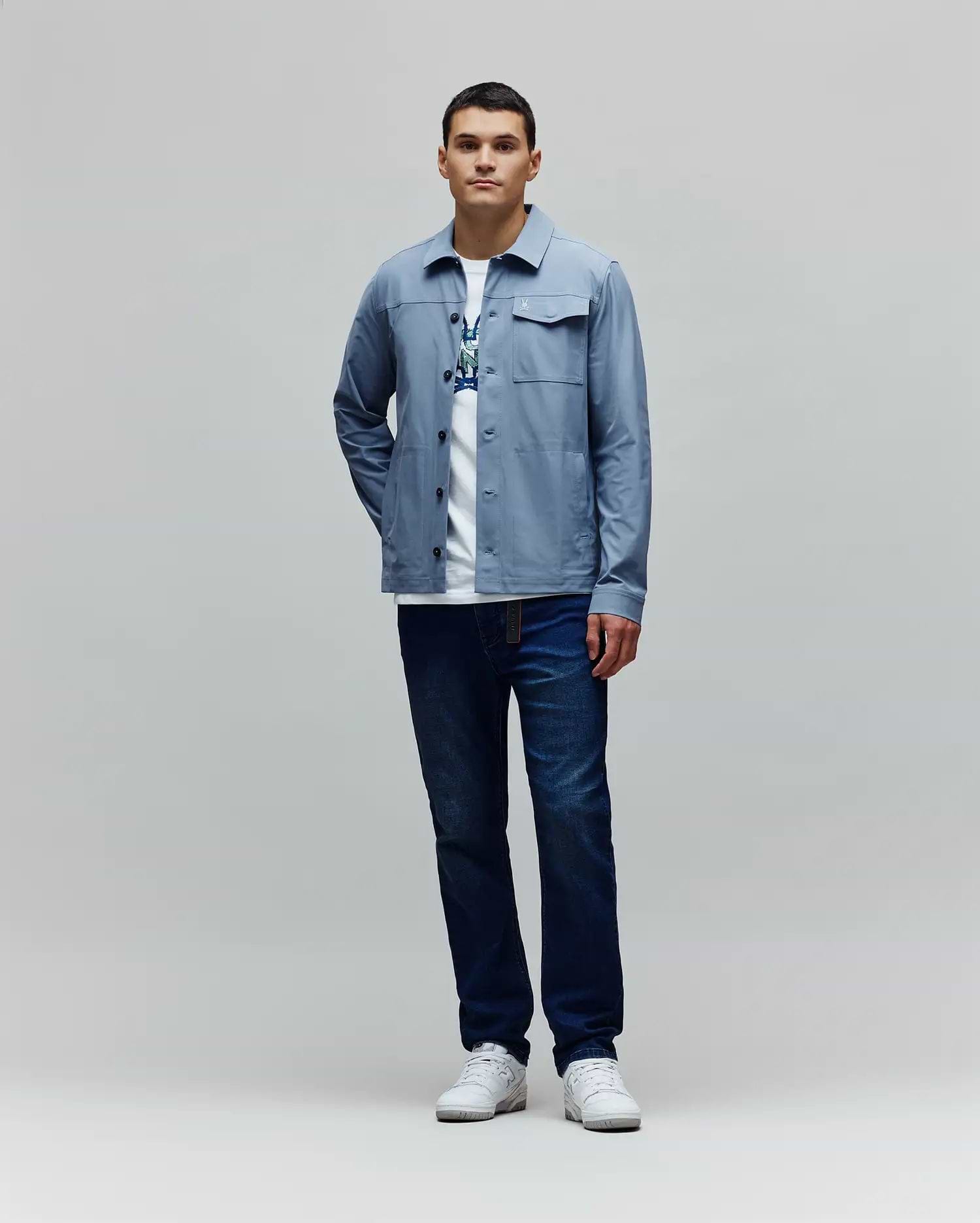 Mens Maverick Overshirt in light blue, featuring a classic fit, smooth fabric, button-front, two chest flap pockets, and a small white embroidered Psycho Bunny skull logo on the left chest. (4)