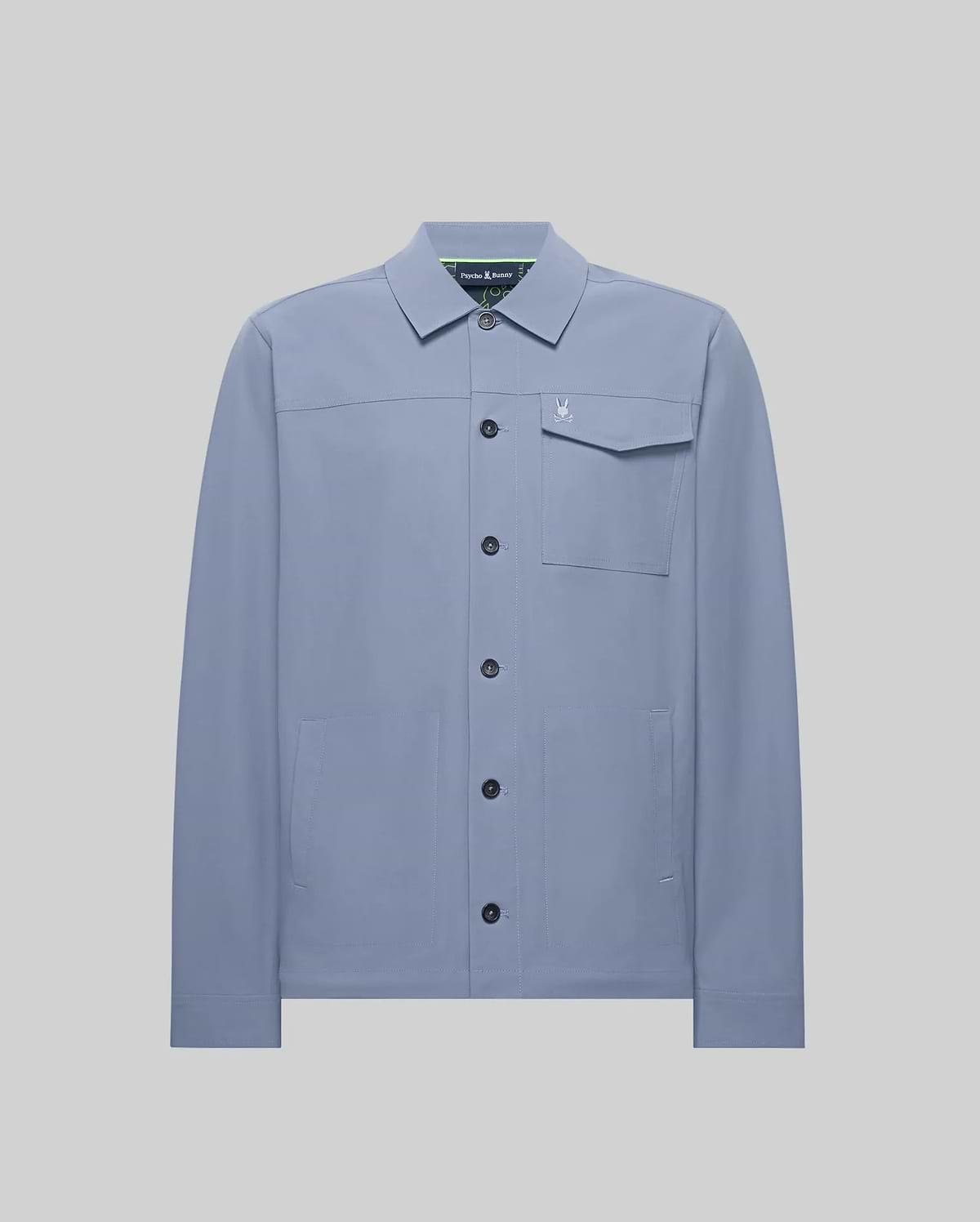 Mens Maverick Overshirt, a dusty blue collared overshirt in smooth fabric, featuring a full button-front, left chest flap pocket with a small embroidered Psycho Bunny skull logo, and two lower welt pockets. (5)