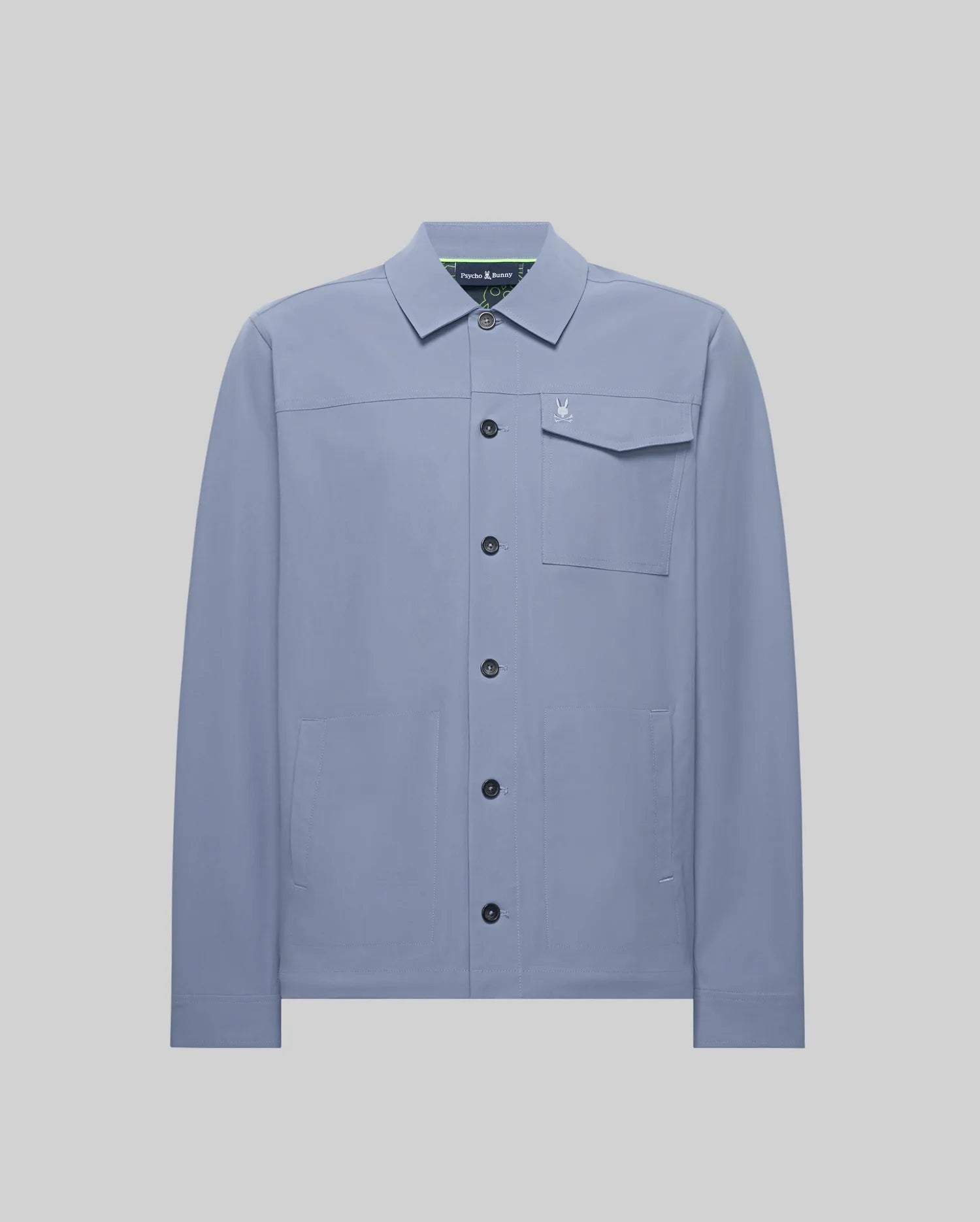 Mens Maverick Overshirt, a dusty blue collared overshirt in smooth fabric, featuring a full button-front, left chest flap pocket with a small embroidered Psycho Bunny skull logo, and two lower welt pockets. (5)