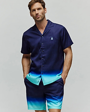 Mens Dax Tencel Shirt, a relaxed fit navy and aqua ombre short-sleeve button-up with a camp collar and small embroidered Psycho Bunny chest logo, paired with matching ombre shorts featuring a leg logo.