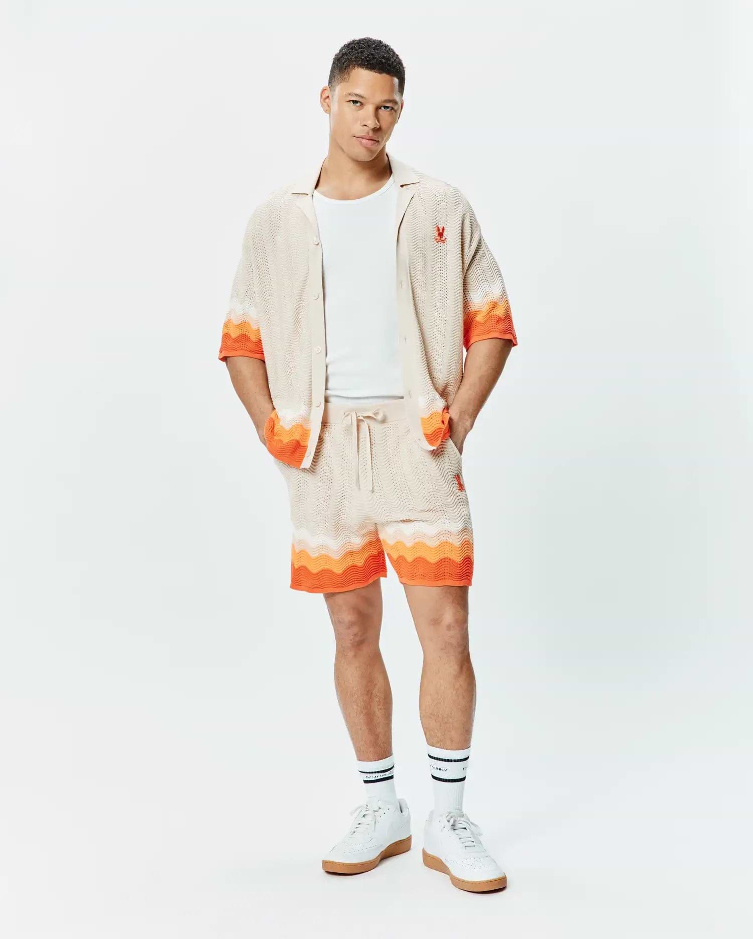 Holden Relaxed Fit Knit Shirt and matching shorts in beige textured knit with orange and white wavy stripes, featuring small embroidered orange Psycho Bunny skull logos.