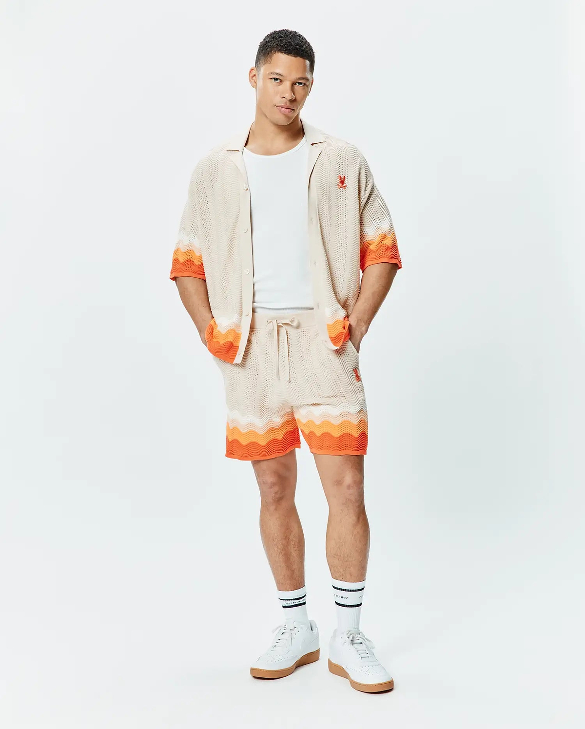 Holden Relaxed Fit Knit Shirt and matching shorts in beige textured knit with orange and white wavy stripes, featuring small embroidered orange Psycho Bunny skull logos.
