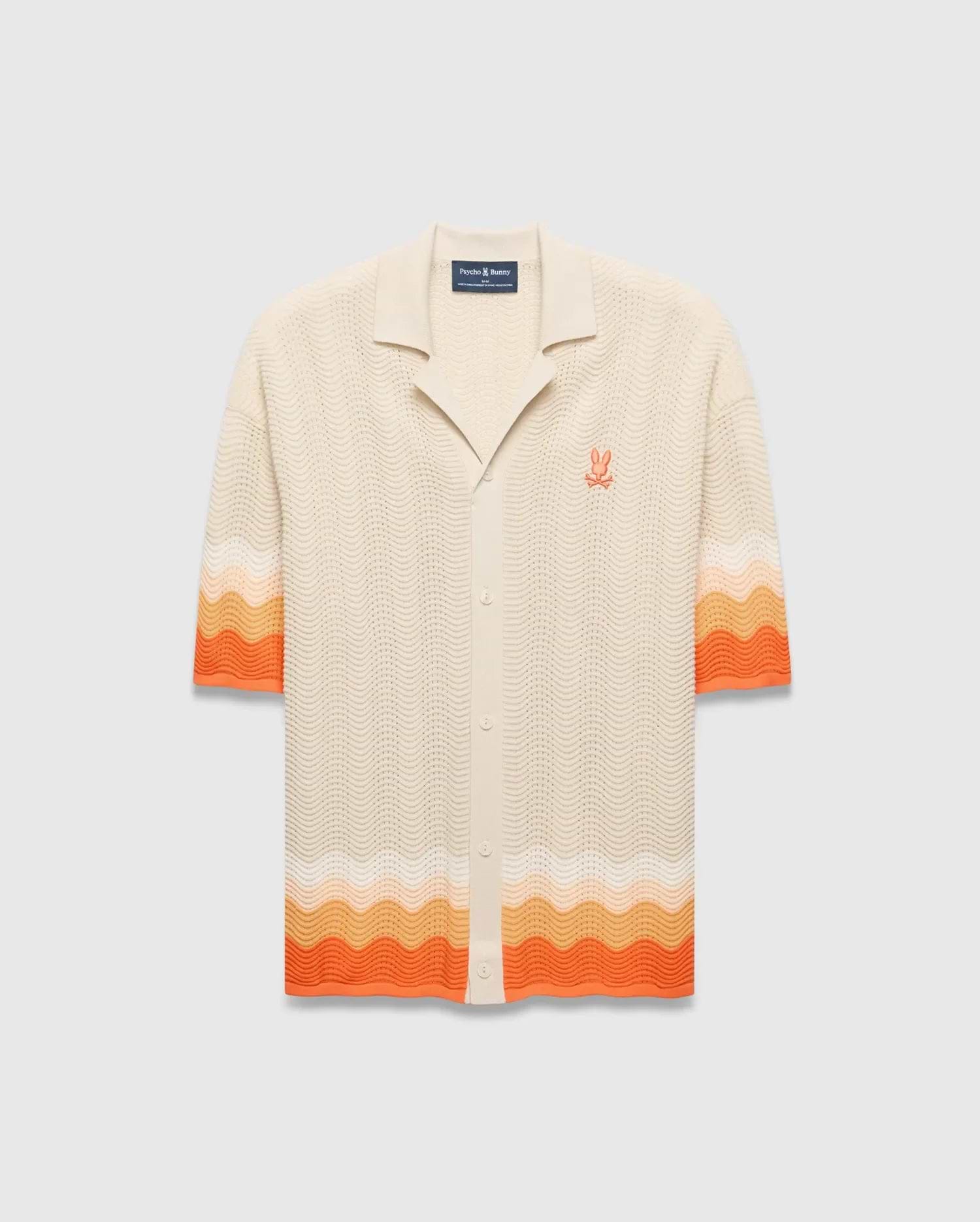 Cream Holden Relaxed Fit Knit Shirt with a wavy knit texture, featuring orange and peach gradient stripes on sleeves and hem, and an embroidered orange Psycho Bunny skull logo on the left chest.
