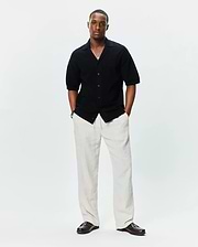 Mens Brad Oversized Knit Shirt, a black textured knit short-sleeve button-front shirt featuring an open collar and a relaxed, oversized fit, embodying refined streetwear style.