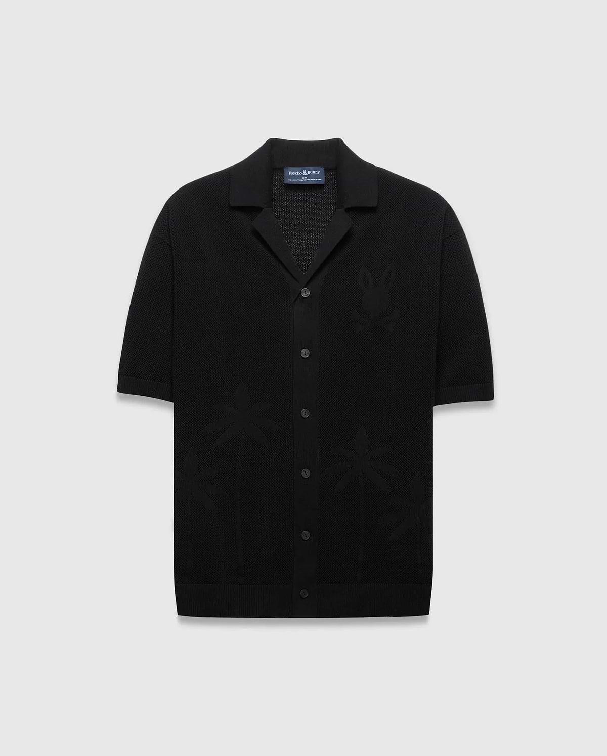Mens Brad Oversized Knit Shirt in black, featuring a textured knit fabric, a subtle tone-on-tone Psycho Bunny skull logo on the left chest, and knit palm tree patterns.
