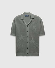 Mens Brad Oversized Knit Shirt in sage green, featuring an open knit texture, a large tonal Psycho Bunny skull logo on the left chest, and subtle palm tree patterns on the lower front.