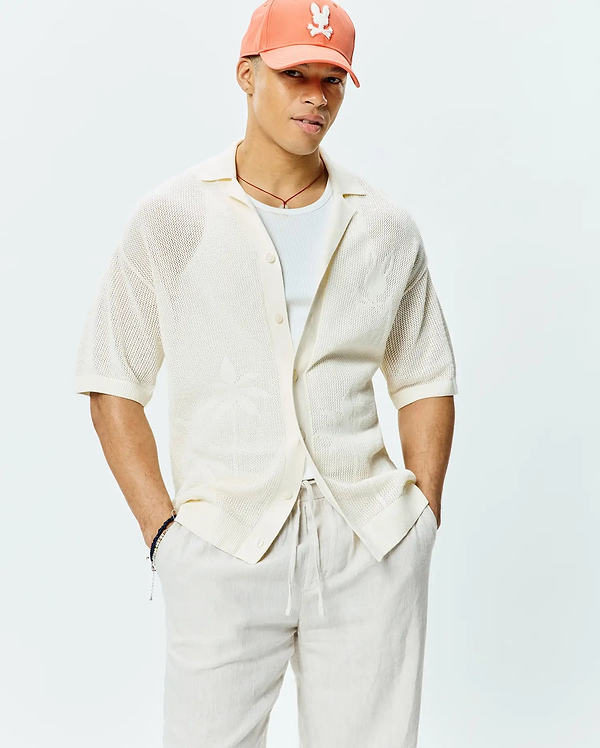 Mens Brad Oversized Knit Shirt in cream, featuring an open knit texture, relaxed fit, short sleeves, spread collar, and subtle woven palm tree pattern.