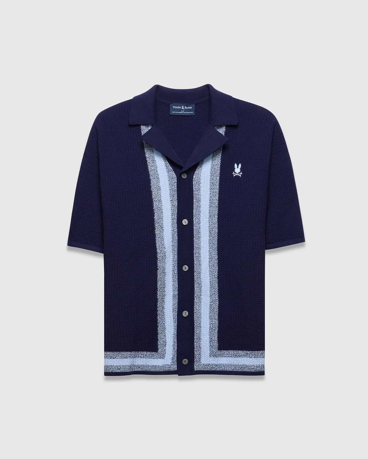 Mens Giles Relaxed Fit Border Knit Shirt in navy, featuring a textured knit, light blue and silver vertical stripes down the placket, a matching hem stripe, and a small white embroidered Psycho Bunny skull logo on the left chest.