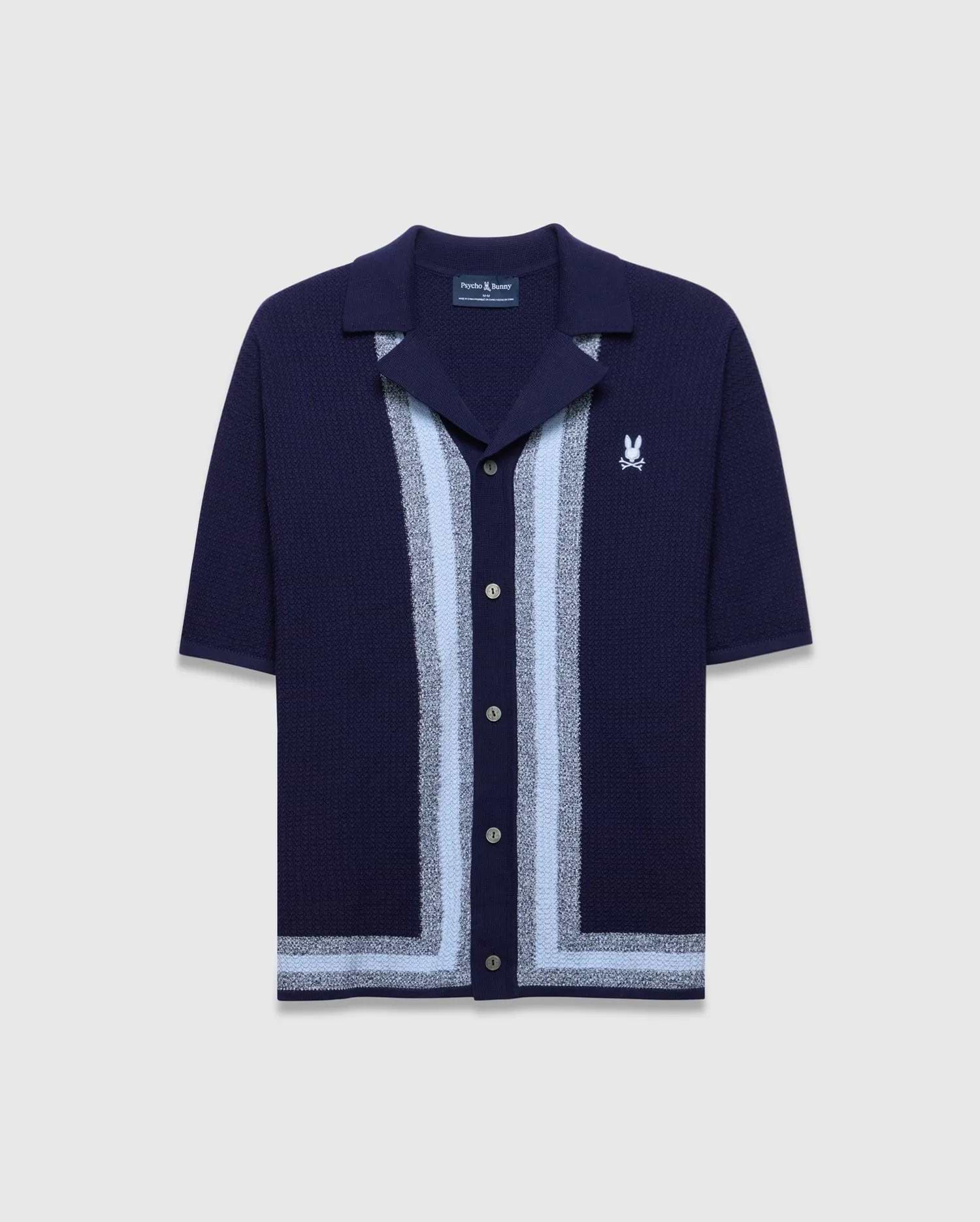 Mens Giles Relaxed Fit Border Knit Shirt in navy, featuring a textured knit, light blue and silver vertical stripes down the placket, a matching hem stripe, and a small white embroidered Psycho Bunny skull logo on the left chest.