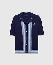 Mens Giles Relaxed Fit Border Knit Shirt in navy, featuring a textured knit, light blue and silver vertical stripes down the placket, a matching hem stripe, and a small white embroidered Psycho Bunny skull logo on the left chest.