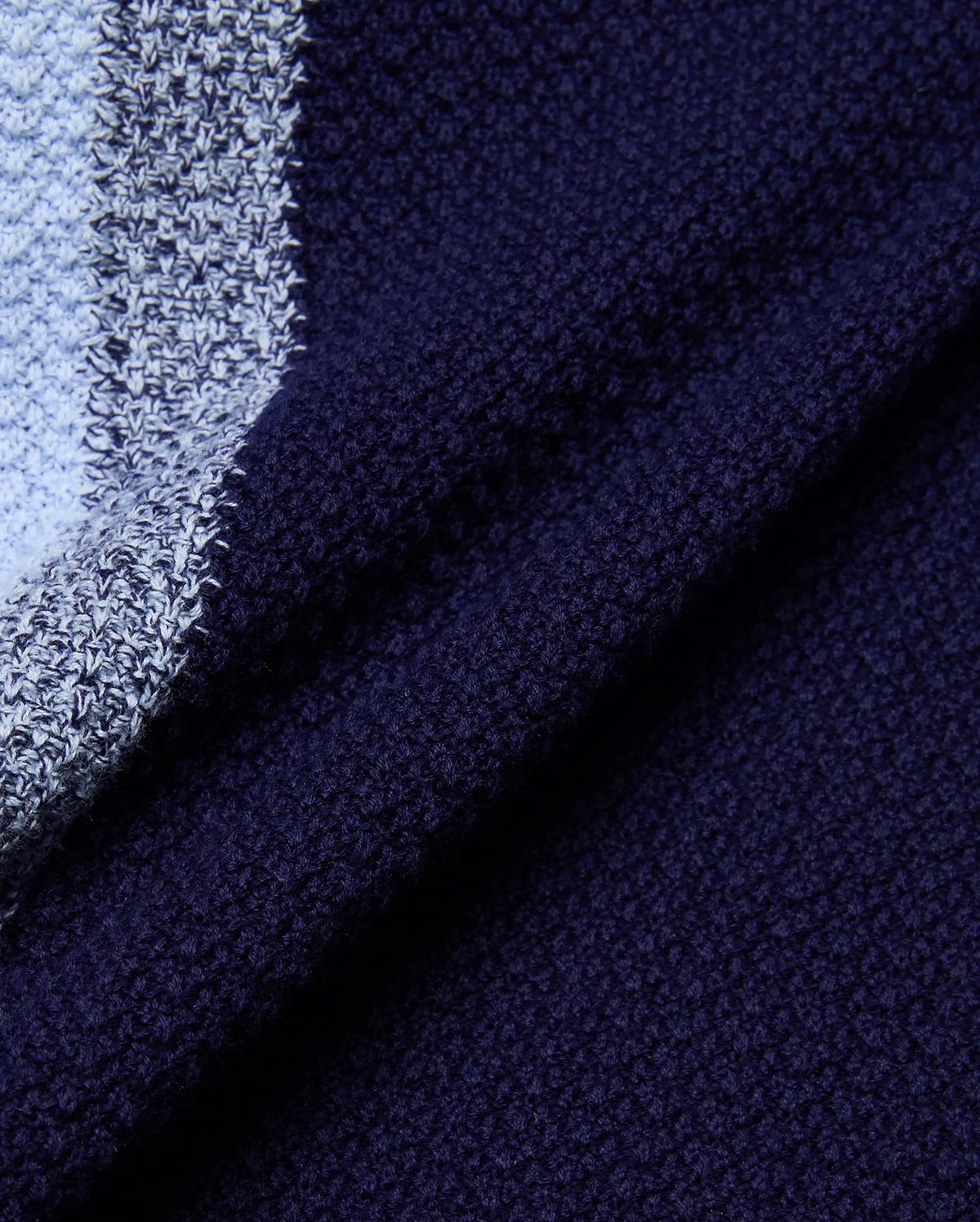 Mens Giles Relaxed Fit Border Knit Shirt, showcasing a rich navy blue textured knit fabric alongside a contrasting light blue and marled grey-white striped knit pattern.