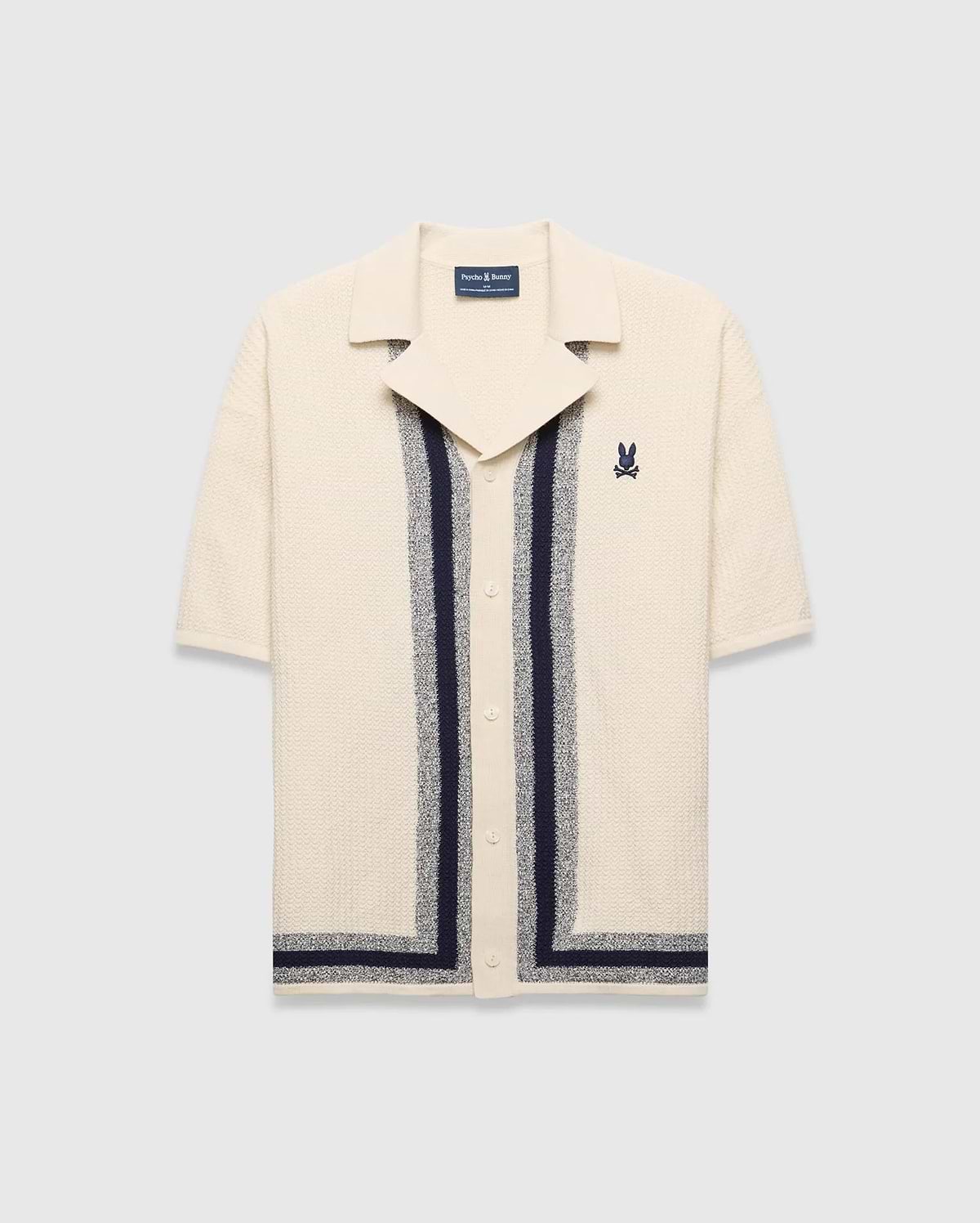 Mens Giles Relaxed Fit Border Knit Shirt in cream textured knit, featuring navy and heather grey vertical stripes, a spread collar, and a small embroidered Psycho Bunny skull on the left chest.