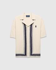 Mens Giles Relaxed Fit Border Knit Shirt in cream textured knit, featuring navy and heather grey vertical stripes, a spread collar, and a small embroidered Psycho Bunny skull on the left chest.