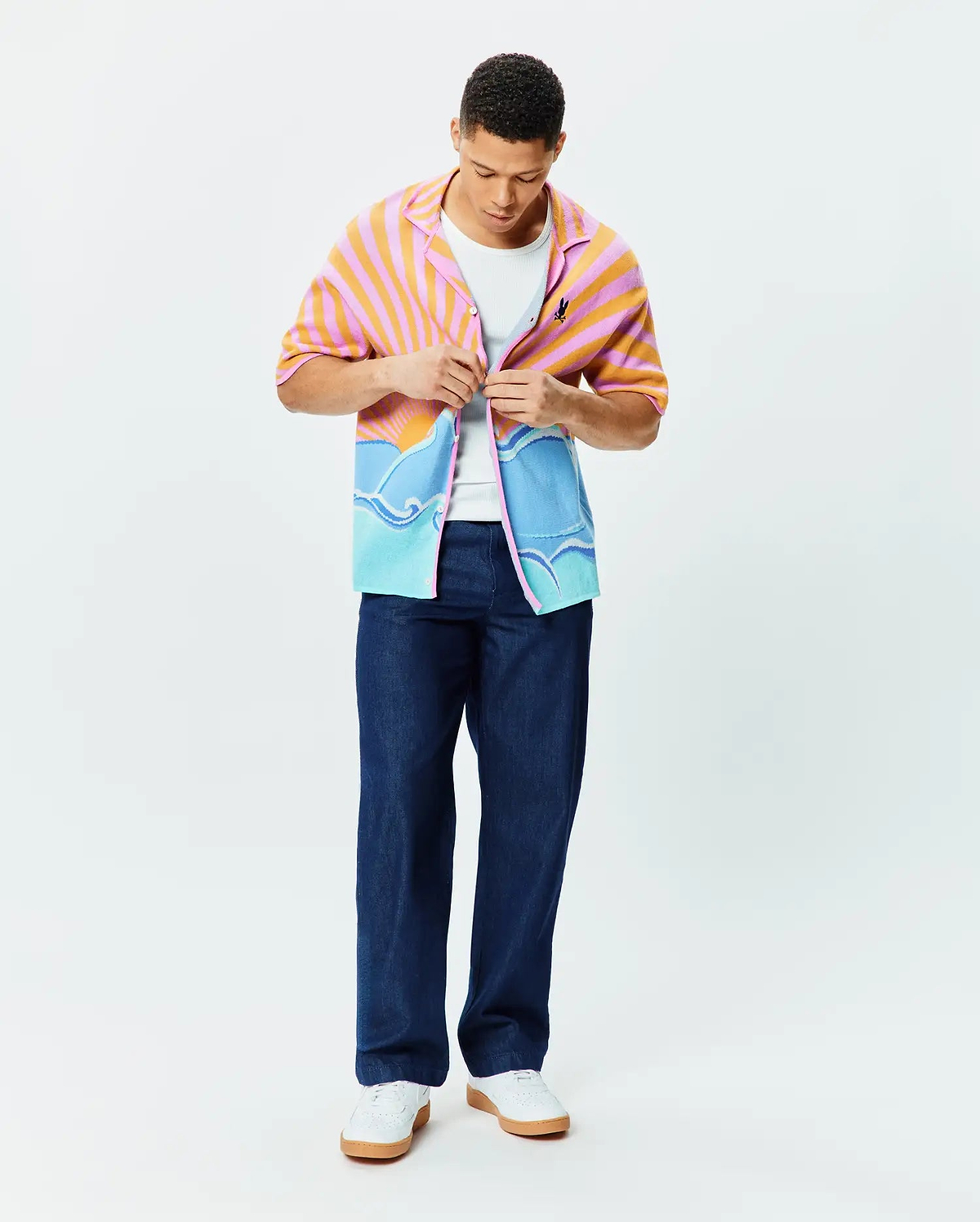 Mens Ray Relaxed Fit Jacquard Shirt featuring a vibrant pink and orange sunrise over blue ocean waves pattern, with a small embroidered Psycho Bunny skull logo on the chest.
